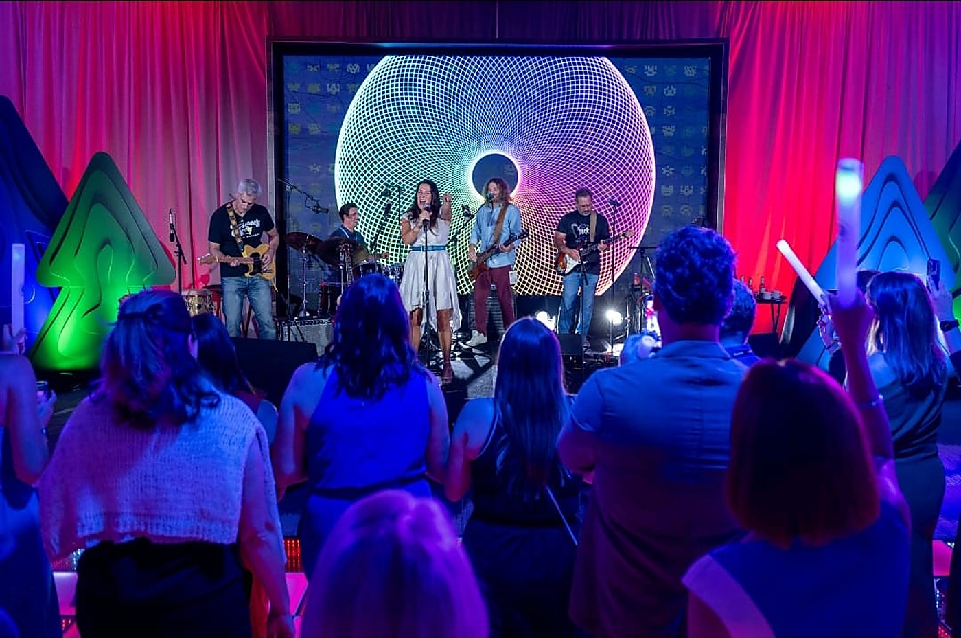 Live band performing under the mesh globe lighting