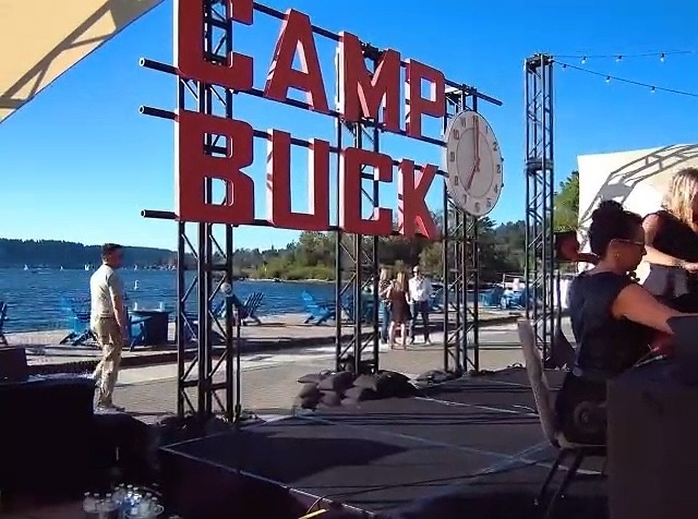 The Camp Buck sign standing against the lake